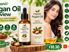 Bottle of 100% Pure Cold-Pressed Virgin Premium Grade Organic Argan Oil with dropper, surrounded by argan nuts on a wooden table.